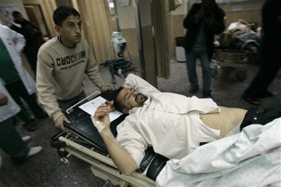 An injured Palestinian man is wheeled into a hospital after being shot, in the West Bank city of Nablus, on Monday. Israeli soldiers intervening in a clash between West Bank residents and Jewish settlers opened fire Monday, wounding eight, Palestinians said. A Palestinian witness said villagers were tending to trees damaged by settlers when settlers attacked them, setting off a rock-throwing clash. 